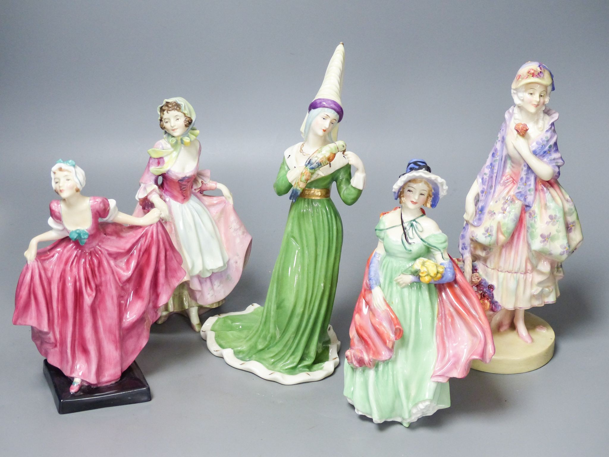 Four Royal Doulton figurines: Phyllis HN1420, Suzette HN1487, Delight HN1772, Lady April HN1965 and another figurine unmarked